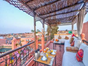 a balcony with a couch and a view of the city at Riad Sun of Kech in Marrakesh