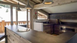 a kitchen with a counter top and a refrigerator at Attività per la famiglia e percorsi per escursioni a piedi o in mountain bike in La Thuile