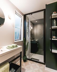 a bathroom with a shower and a sink and a mirror at Camping VITAMIN DIEPPE in Saint-Aubin-sur-Scie