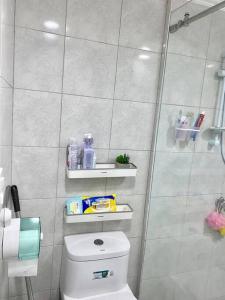 a small bathroom with a toilet and a shower at Studio type with Free Parking in Kababae