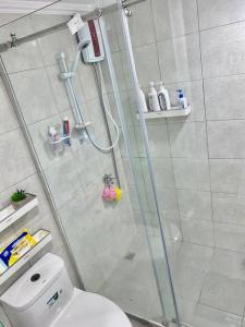 a bathroom with a shower and a toilet at Studio type with Free Parking in Kababae