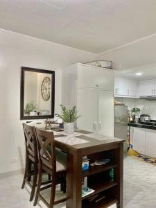 a kitchen with a table with chairs and a sink at Studio type with Free Parking in Kababae