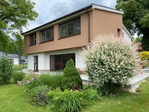 a house with a garden in front of it at Residence Dymokury in Dymokury