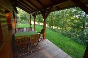une terrasse couverte avec une table et des chaises. dans l'établissement Meadow Ranch Holiday Home, à Jaroslavické Paseky