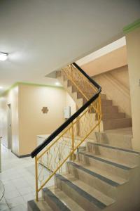 a staircase in a building with a metal railing at Penginapan AIRA in Palu