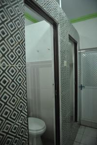 a bathroom with a toilet and a mirror at Penginapan AIRA in Palu