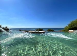 a large pool of water with the ocean in the background at Royal Azur Thalassa in Hammamet