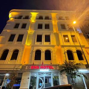 a yellow building with a sign in front of it at Ens Hotel in Istanbul