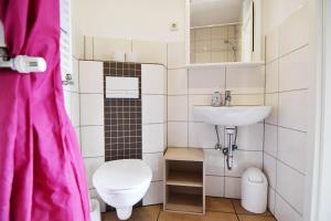 a small bathroom with a toilet and a sink at Work and Stay Troisdorf in Troisdorf