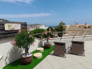 a balcony with three potted plants on a roof at Apartamento Lliris Atico in L'Estartit