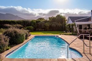 a swimming pool in the backyard of a house at The Dongola Guesthouse in Cape Town