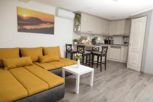 a living room with a couch and a table at Aranyos Hillside in Nagymaros