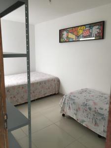 a bedroom with a bunk bed and a ladder next to a bed at Casa de Praia Tamandare in Tamandaré +15 photos