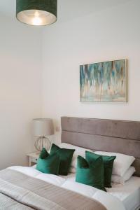 a bedroom with a large bed with green pillows at Apartment 8 2 bedrooms, sleeps x 6 in York