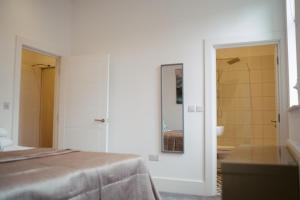 a room with a bed and a bathroom with a mirror at Apartment 8 2 bedrooms, sleeps x 6 in York