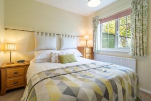 a bedroom with a large bed and a window at Field End in Westleton