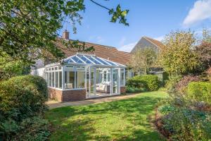 a house with a conservatory in a yard at Field End in Westleton