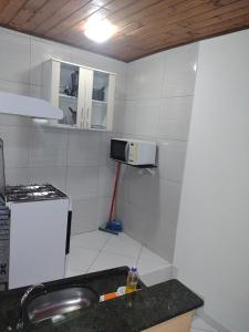 Il comprend une petite cuisine équipée d'un évier et d'un four micro-ondes. dans l'établissement Apartamentos em Pipa RN, à Pipa