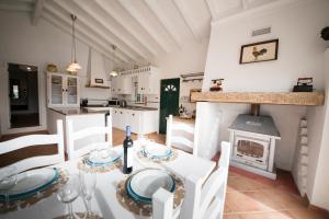 a kitchen with a dining table and a stove at Monte Lusitano Sossego in Grândola