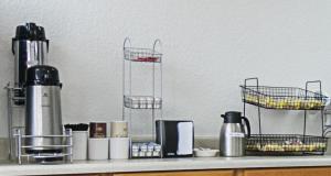 a kitchen counter with two wire baskets on a shelf at Red Roof Inn Forsyth in Forsyth