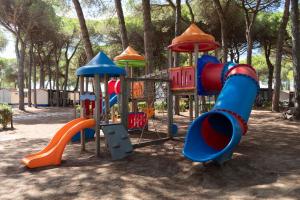 a playground in a park with a slide at Pineta Sul Mare Camping Village in Cesenatico
