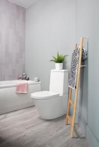 a bathroom with a toilet with a plant on it at Beautiful first floor apartment in Poulton le Fylde