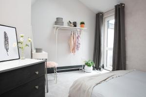 a bedroom with a bed and a dresser and a window at Beautiful first floor apartment in Poulton le Fylde