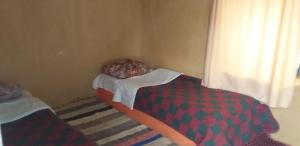 Postel nebo postele na pokoji v ubytování Auberge Camping La Khaima