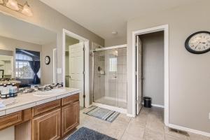 een badkamer met een wastafel, een douche en een klok bij 21361 White Ash Ct in Parker +39 foto's