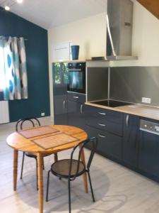 a kitchen with a wooden table and chairs in a kitchen at Eden in Ore +7 photos