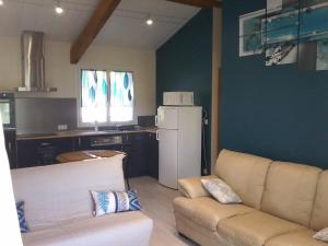 a living room with a couch and a refrigerator at Eden in Ore