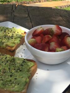 a plate with a bowl of fruit and toast at Tiret Riverside Resort and Retreat in Eldoret
