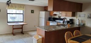 a kitchen with a sink and a counter top at Sea Club Condo #6 in Clearwater Beach