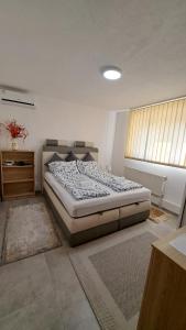 a bedroom with a bed in a room with a window at Elita Prenoćište in Bihać