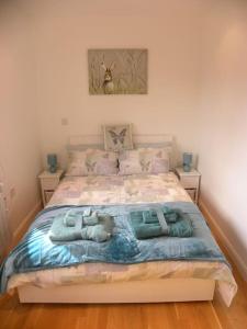 a bedroom with a bed with three pillows on it at Oakey Orchard - cosy apartment in Tamar Valley, Cornwall in Saint Dominick