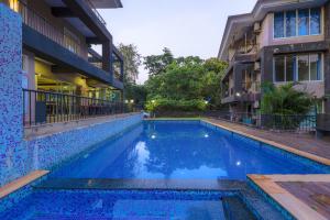 a swimming pool in front of a building at 4BHK SPARKLING APARTMENT NEAR BEACH POOL & BAR 2bhkX2 in Vagator