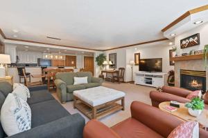 a living room filled with furniture and a fireplace at St James Place by East West Hospitality in Beaver Creek