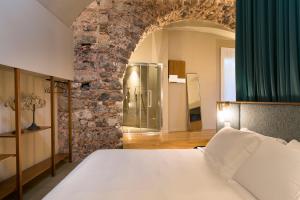 Ένα ή περισσότερα κρεβάτια σε δωμάτιο στο BASTIÒ PRIVATE SUITES