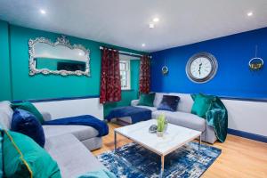 a blue living room with a couch and a table at Perfect Place To Stay Fast Free WiFi in Edinburgh