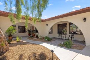 a courtyard in a house with a table and chairs at Luxury villa with pool and spa in Las Vegas