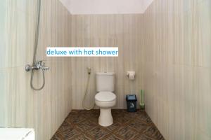 a bathroom with a toilet in a shower at Padanta Gili Trawangan in Gili Trawangan