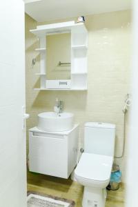 a white bathroom with a sink and a toilet at Apartman Dina in Soko Banja +24 photos