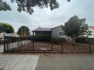 a black metal fence in front of a house at Lucky House in Long Beach