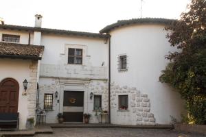 ein altes weißes Haus mit einem Steingebäude in der Unterkunft Ca'stello23 in Sala Bolognese