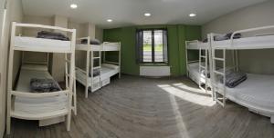 a room with four bunk beds in a room at ALBERGUE SAN MARCOS in Palas de Rei 