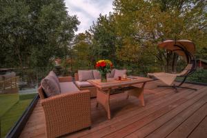 a wooden deck with a table and chairs on it at Waterfall Glamping Cabin in Bihać