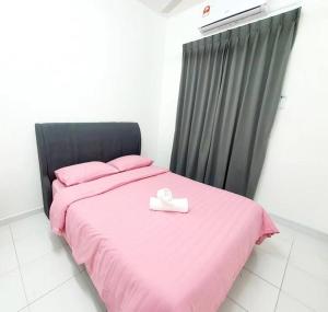 a pink bed with a box on top of it at 2-Storey Near Aeon Bukit Indah/ Legoland (6 paxs) in Johor Bahru