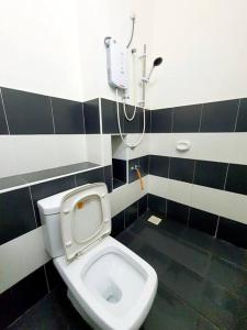 a bathroom with a white toilet and a shower at 2-Storey Near Aeon Bukit Indah/ Legoland (6 paxs) in Johor Bahru