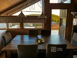 a dining room with a wooden table and chairs at Modern sports cabin on Sjusjøen with sauna and waxing room in Ringsaker +27 photos