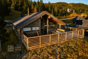 an overhead view of a house with a gambrel roof at Modern sports cabin on Sjusjøen with sauna and waxing room in Ringsaker